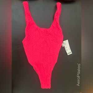 Bright pink one piece bathing suit from Urban Outfitters.